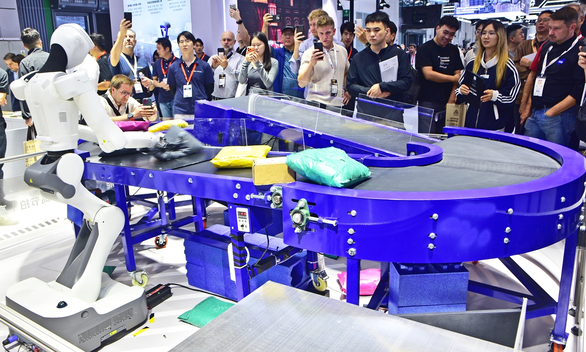 Visitors view a demonstration of robotic logistics sorting solutions at the 26th China International Industry Fair (CIIF) in Shanghai on October 12, 2026. The CIIF is the longest-running national-level industrial event in China. Integrating exhibitions, trade, awards, and forums, the CIIF drives global innovation and collaboration in smart and sustainable manufacturing. Photo: VCG