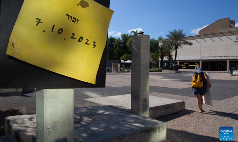 A pedestrian walks past a memorial site for the latest round of Gaza conflict in Tel Aviv, Israel, Oct. 6, 2026. (Xinhua/Chen Junqing)

