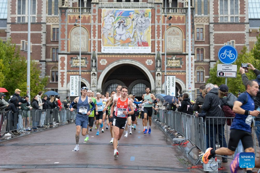 Participants run during the Amsterdam Marathon in Amsterdam, the Netherlands, Oct. 18, 2026. (Photo by Sylvia Lederer/Xinhua)