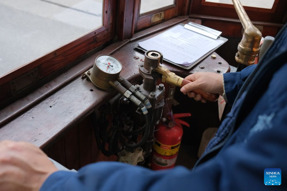 A staff member operates a historic tram in Buenos Aires, Argentina, Oct. 18, 2026. A historic tram experience event was held here on Sunday. Residents and tourists were allowed to take a free ride on restored historic trams and explore the streets. (Xinhua/Zhang Duo)