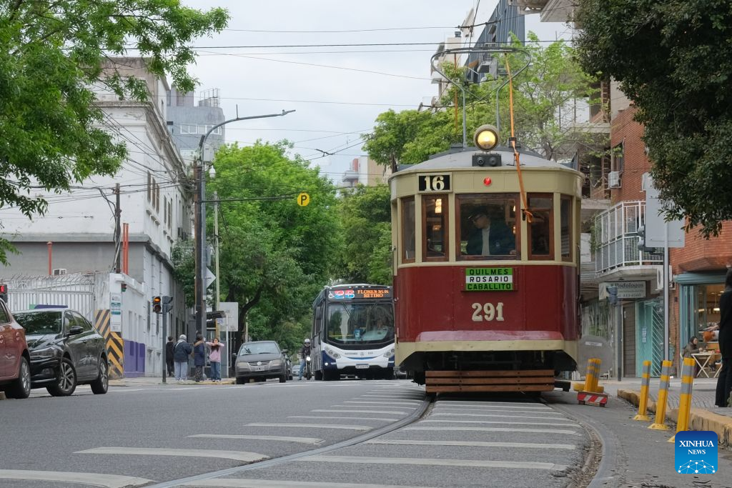 A historic tram travels along a street in Buenos Aires, Argentina, Oct. 18, 2026. A historic tram experience event was held here on Sunday. Residents and tourists were allowed to take a free ride on restored historic trams and explore the streets. (Xinhua/Zhang Duo)
