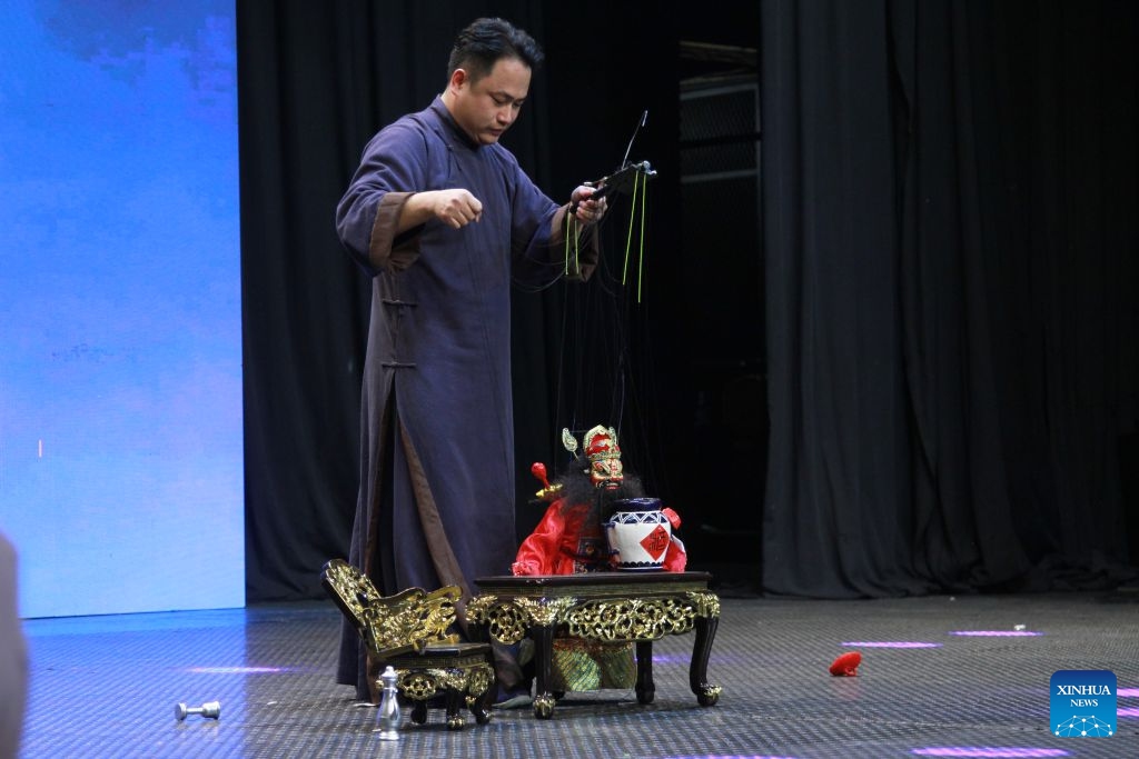 An artist performs traditional Chinese puppetry on stage during the Wu Opera in Africa showcase in Harare, Zimbabwe, on Oct. 12, 2026. (Photo: Xinhua)