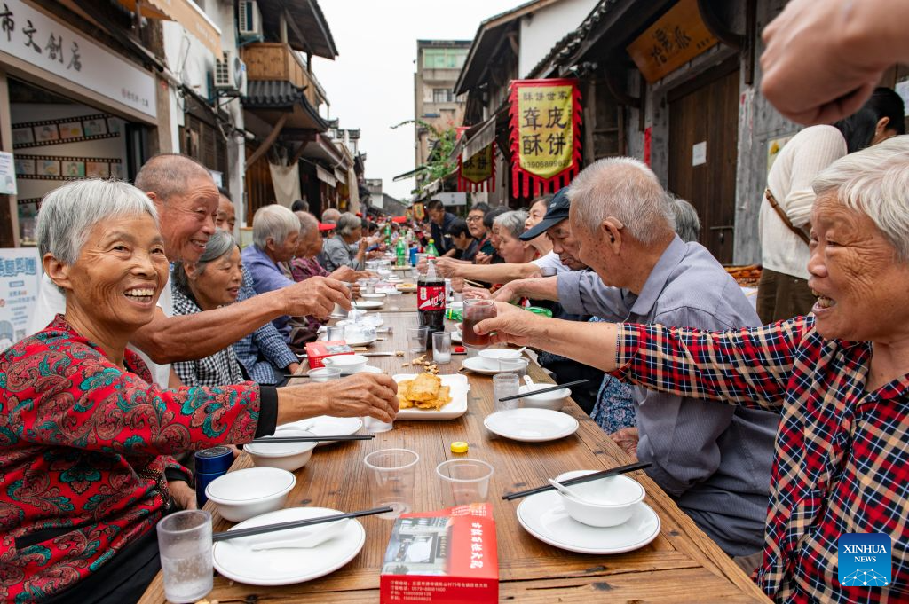 Elderly people attend a long-table banquet in Yanggang Village of Lanxi, east China's Zhejiang Province, Oct. 15, 2026. Funded by kind-hearted people, the banquet held on Thursday was attended by more than 500 people aged 60 and above to mark the upcoming Double Ninth Festival. Celebrated on the ninth day of the ninth lunar month, it is an occasion to care for and send blessings to older people in China. (Photo by Hu Xiaofei/Xinhua)