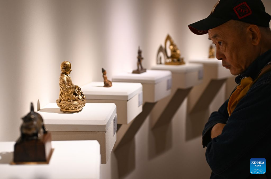 A visitor views artworks at the 2026 Beijing China Art International Fair in Beijing, capital of China, Oct. 20, 2026. With a theme of Cultural Heritage Bridges Life to a Vibrant World, the fair kicked off here on Tuesday. (Xinhua/Chen Zhonghao)