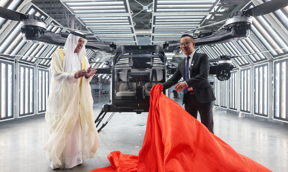 Sheikh Saud bin Saqr Al Qasimi (left), UAE Supreme Council Member and Ruler of Ras Al Khaimah, and Zhao Deli, founder of XPENG AEROHT (ARIDGE),  jointly unveil the Land Aircraft Carrier (X3-F) flying car at the ARIDGE mass-production factory in Guangzhou, South China's Guangdong Province, on October 20, 2026. The X3-F will be the first flying car for a low-altitude flight supervision demonstration zone in the UAE. Photo: Cui Meng/Global Times