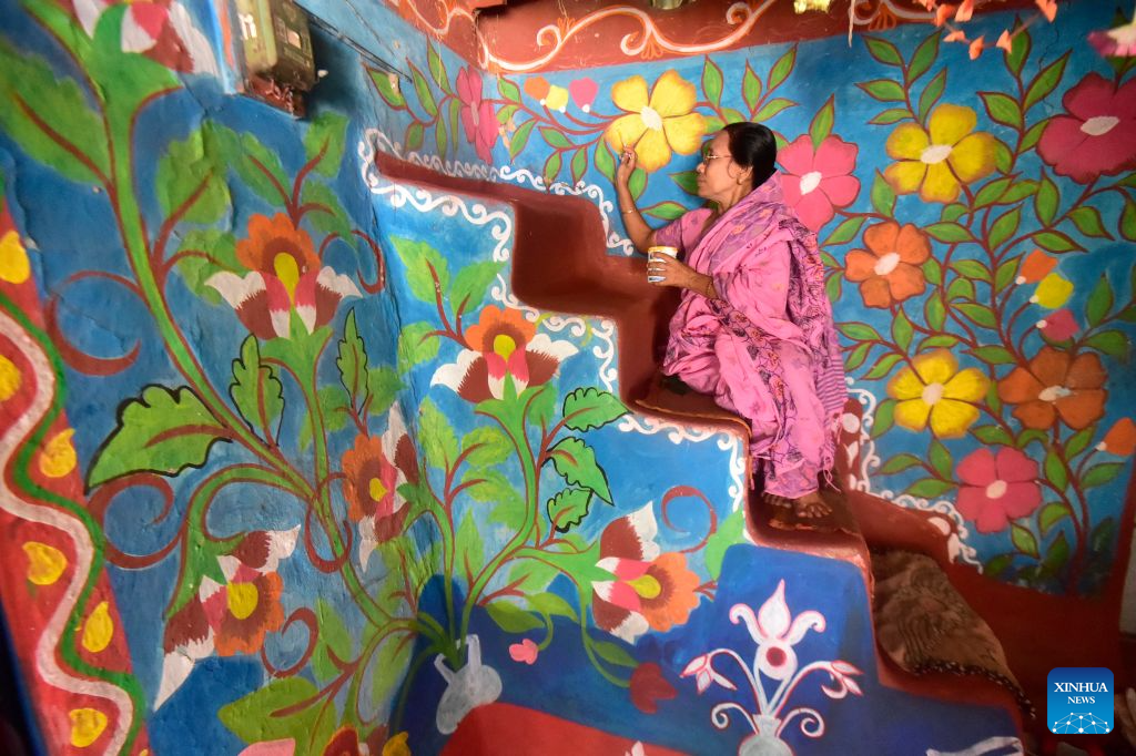 A woman paints Alpona in a village in Chapainawabganj District, Bangladesh, Oct. 18, 2026. Alpona is a traditional form of folk art practiced in South Asia and is mainly created by women in the local community. (Photo by Habibur Rahman/Xinhua)