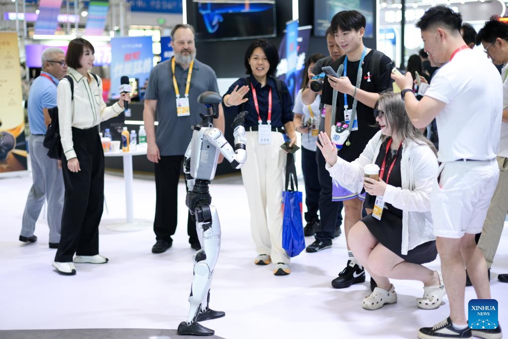 Visitors interact with a Unitree Robotics' humanoid robot during the sixth China International Consumer Products Expo (CICPE) in Haikou, south China's Hainan Province, April 14, 2026. The ongoing sixth CICPE features groundbreaking innovations in artificial intelligence (AI). A wide range of new tech consumer products are showcased at the event, spanning multiple sectors including smart interaction, wearable devices, and smart healthcare. (Photo: Xinhua)