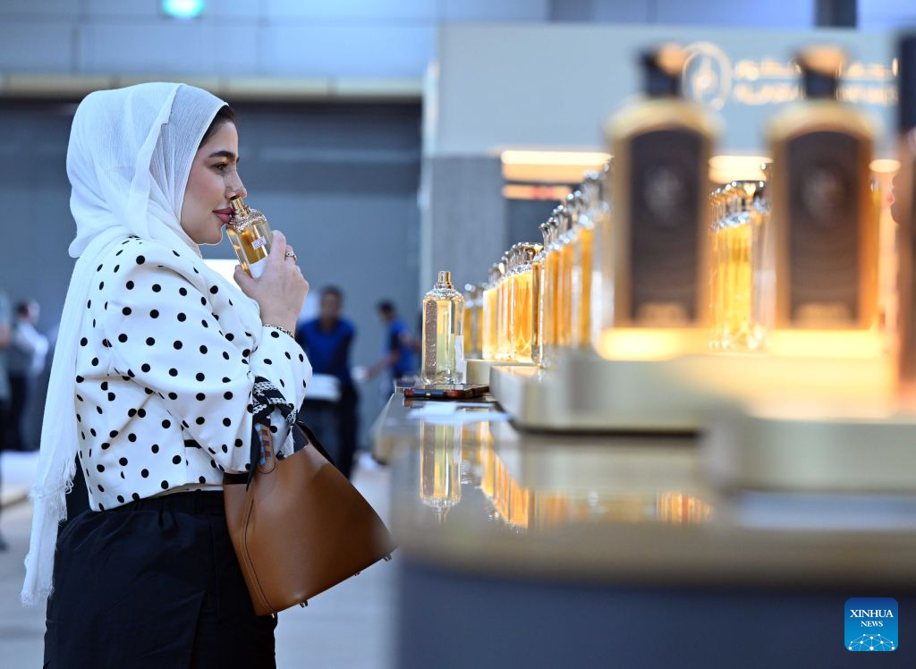 A woman samples perfume at a perfume exhibition in Hawalli Governorate, Kuwait, Oct. 20, 2026. A perfume exhibition opened Tuesday at the Kuwait International Fairground in Mishref, Hawalli Governorate, Kuwait, attracting more than 500 exhibitors. Running through Oct. 31, the exhibition features a wide range of products, including perfumes, incense, aromatic oils, as well as beauty and personal care products. (Photo by Asad/Xinhua)