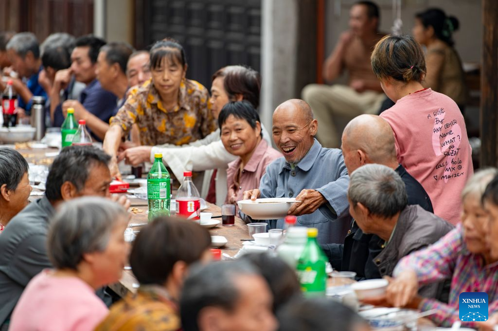 Elderly people attend a long-table banquet in Yanggang Village of Lanxi, east China's Zhejiang Province, Oct. 15, 2026. Funded by kind-hearted people, the banquet held on Thursday was attended by more than 500 people aged 60 and above to mark the upcoming Double Ninth Festival. Celebrated on the ninth day of the ninth lunar month, it is an occasion to care for and send blessings to older people in China. (Photo by Hu Xiaofei/Xinhua)