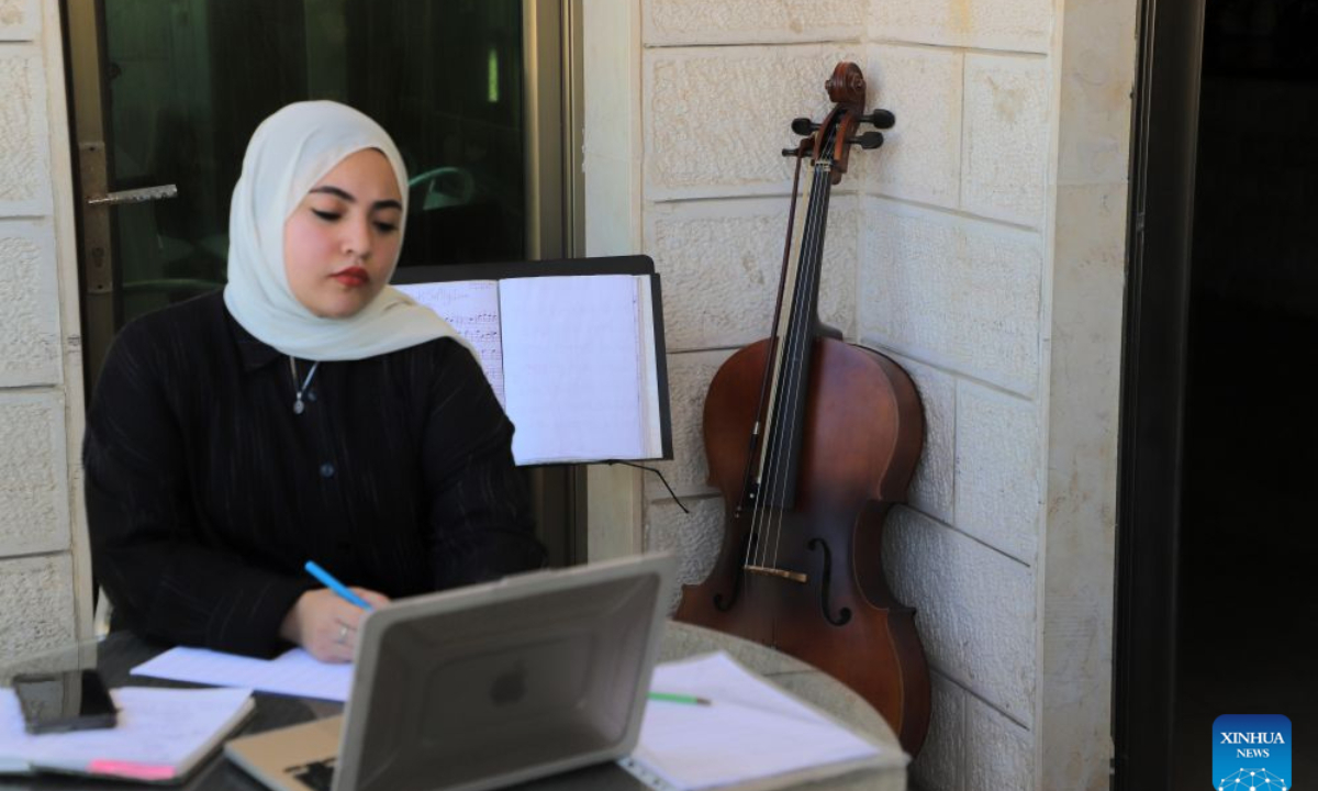 Palestinian artist Haifa Bassam Abu Shamla composes music at her residency in Gaza City, on Oct. 4, 2026. (Photo by Rizek Abdeljawad/Xinhua)