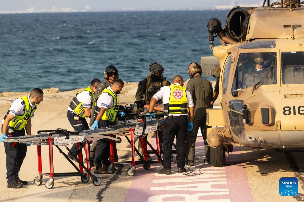 An injured person is transferred to Rambam Hospital in Haifa, northern Israel, Oct. 12, 2026. One person was killed and 19 others injured in an explosion of unexploded ordnance during a school trip in northern Israel on Monday, Israeli police and the national emergency service Magen David Adom said in separate statements. (Photo: Xinhua)