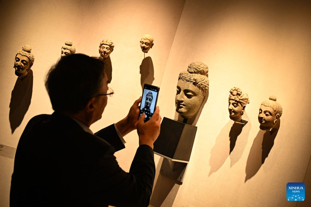A visitor takes photos of an artwork at the 2026 Beijing China Art International Fair in Beijing, capital of China, Oct. 20, 2026. With a theme of Cultural Heritage Bridges Life to a Vibrant World, the fair kicked off here on Tuesday. (Xinhua/Chen Zhonghao)