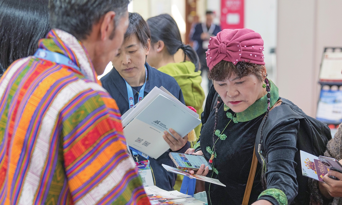 Visitors browse travel information at the China Outbound & Inbound Travel Market in Beijing on October 14, 2026. The event attracted about 200 exhibitors and buyers from China and overseas, including tourism organizations from more than 30 countries and regions. Photo: CNS Photo