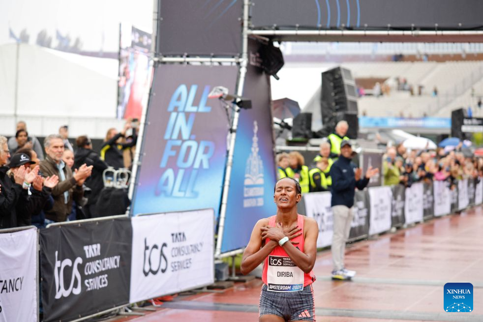 Buze Diriba of Ethiopia celebrates after winning the women's race of the Amsterdam Marathon in Amsterdam, the Netherlands, Oct. 18, 2026. (Photo by Sylvia Lederer/Xinhua)