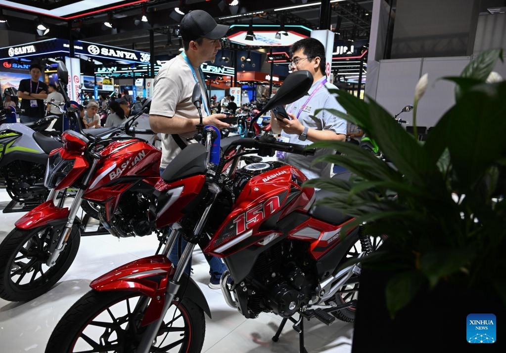 An overseas buyer (L) holds talks at the exhibition area for motorcycles during the 140th Canton Fair in Guangzhou, south China's Guangdong Province, Oct. 18, 2026. The on-site exhibition of the first phase of the 140th edition of the China Import and Export Fair, also known as the Canton Fair, concluded here on Monday. As of October 19, the fair has attracted 189,000 overseas buyers from 214 countries and regions, a 13.3 percent increase from the session of the same period last year and a new high, according to the China Foreign Trade Centre (CFTC), the organizer of the fair. (Xinhua/Deng Hua)