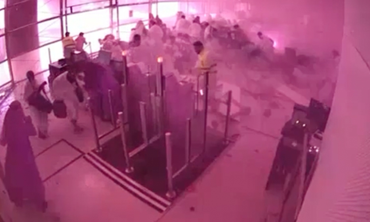 This image from a CCTV video released by Saudi Arabia's Media Ministry shows passengers taking cover as flames and smoke fill part of King Khalid International Airport in Riyadh, Saudi Arabia, during a strike at the airport on October 10, 2026. Photo: VCG
