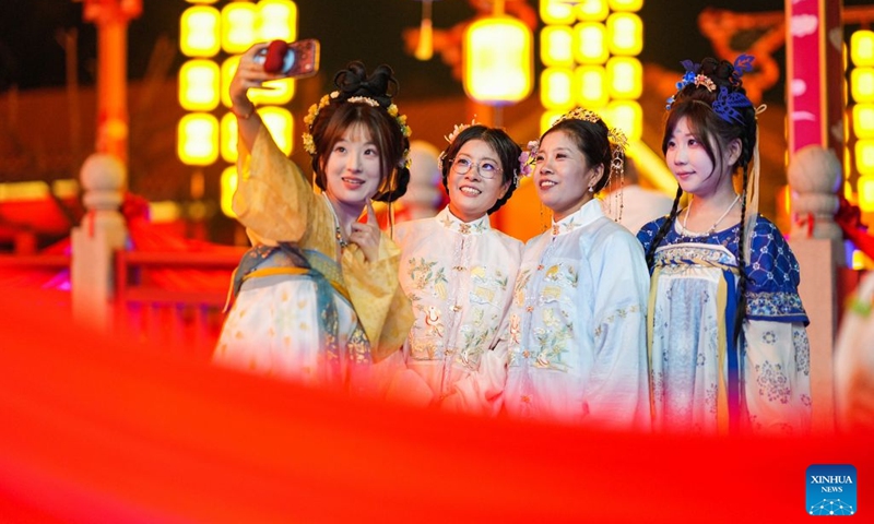 People pose for photos at the Eastern Acropolis in Binhai New Area of Tianjin, north China, Oct. 11, 2026. Eastern Acropolis, a cultural and tourism complex in Beitang ancient town of Tianjin, launched its trial operation on Sunday. The complex, built upon the town's original infrastructure and themed on Tianjin's history and culture, offers immersive performances, cultural experiences, specialty stores and leisure options for visitors. (Photo: Xinhua)