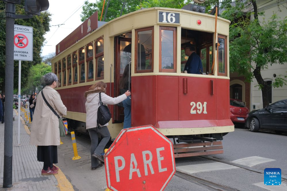 Residents and tourists board a historic tram in Buenos Aires, Argentina, Oct. 18, 2026. A historic tram experience event was held here on Sunday. Residents and tourists were allowed to take a free ride on restored historic trams and explore the streets. (Xinhua/Zhang Duo)