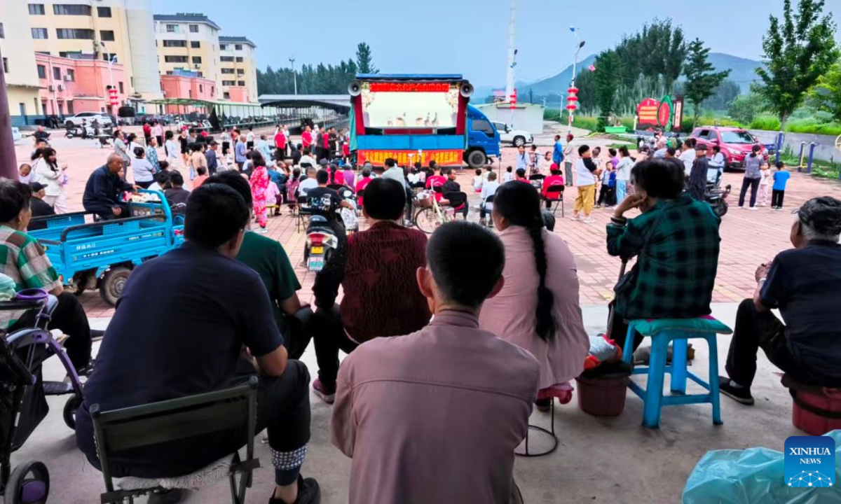 People watch a shadow play in Sandaohezi Town of Lingyuan City, northeast China's Liaoning Province, July 10, 2026.(Xinhua)