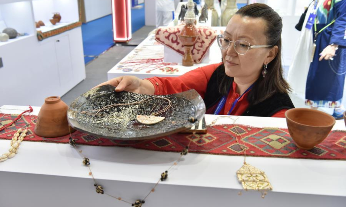A Kazakh ceramist arranges a porcelain piece during the 2026 China Jingdezhen International Ceramic Expo in Jingdezhen, east China's Jiangxi Province, Oct. 18, 2026. (Photo by Shi Weiming/Xinhua)