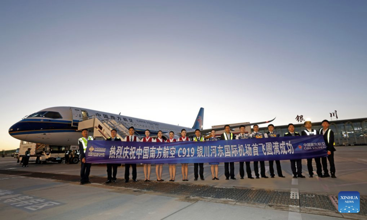 Crew members of the China Southern Airlines flight CZ3925 and staff members of the Yinchuan Hedong International Airport pose for group photos after the landing of a C919 aircraft at the airport in Yinchuan, northwest China's Ningxia Hui Autonomous Region, Oct. 20, 2026. China's homegrown C919 large passenger aircraft landed at the airport at 5:57 p.m. on Tuesday after departing from Changsha in central China's Hunan Province, marking the aircraft's first commercial passenger flight to Yinchuan. (Xinhua/Wang Peng)