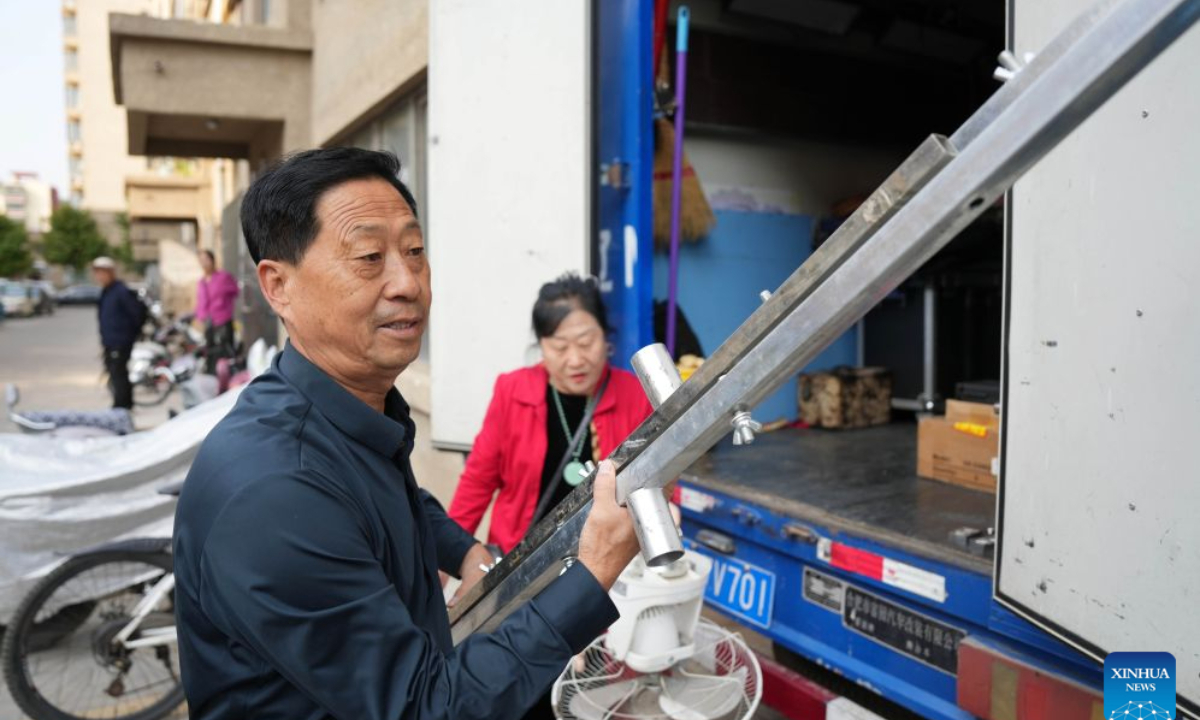 Xu Zilin (front) arranges stage props for shadow puppetry performance in Lingyuan City, northeast China's Liaoning Province, Oct. 10, 2026.
Lingyuan shadow puppetry, a national-level intangible cultural heritage in China, comes vividly alive amid dazzling light and shadow. Movements of the puppets embody the local folk traditions, which have been passed down through generations.
Xu Zilin was born in 1964 to a family that has the Lingyuan shadow puppetry as its walk of life for ages. More than 40 years of professional experience made Xu a representative inheritor of the craft and an influential figure in the trade. Many of his vocal passages have been modeled for teaching.
To better promote shadow plays, Xu founded a shadow puppetry troupe and brought quality productions to the grassroots level. Over the years, Xu and his troupe have performed more than 4,000 shows in Liaoning and neighboring provinces. (Xinhua/Li Gang)
