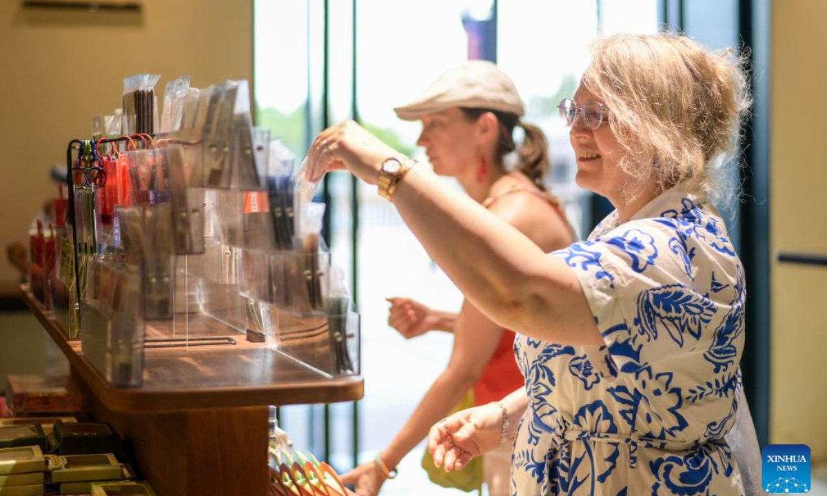Tourists from Russia select cultural and creative products at a bookstore in Jiangbei District of Ningbo City, east China's Zhejiang province, July 28, 2026. Thanks to the visa-free entry policies, China has witnessed an increasing number of foreign tourists visiting China this summer. According to the official data, 77.7 percent of foreign visitors entering China in the first half of the year enjoyed visa-free entry policies. (Xinhua/Jiang Han)
