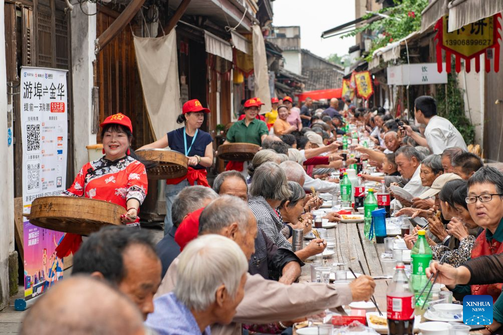 Elderly people attend a long-table banquet in Yanggang Village of Lanxi, east China's Zhejiang Province, Oct. 15, 2026. Funded by kind-hearted people, the banquet held on Thursday was attended by more than 500 people aged 60 and above to mark the upcoming Double Ninth Festival. Celebrated on the ninth day of the ninth lunar month, it is an occasion to care for and send blessings to older people in China. (Photo by Hu Xiaofei/Xinhua)