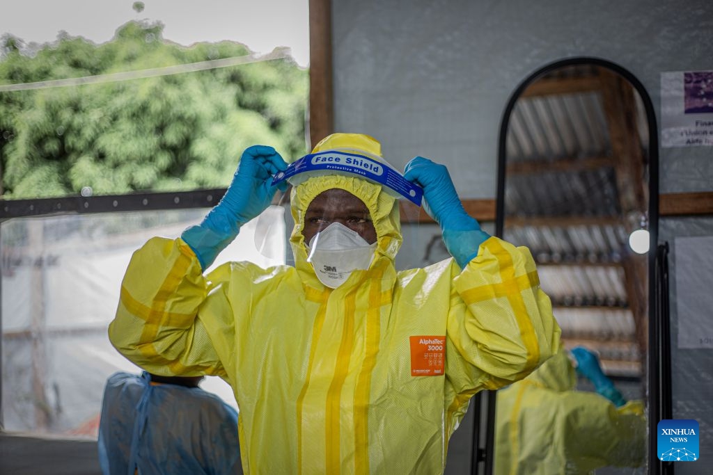 A health worker puts on a protective suit at an Ebola treatment center in Bunia, capital of Ituri Province in the Democratic Republic of the Congo (DRC), on Oct. 12, 2026. The Democratic Republic of the Congo (DRC) has recorded more than 9,000 confirmed cases of Ebola since the outbreak was declared on May 15, with the death toll rising to 4,381, according to the latest situation report released Tuesday. (Photo: Xinhua)