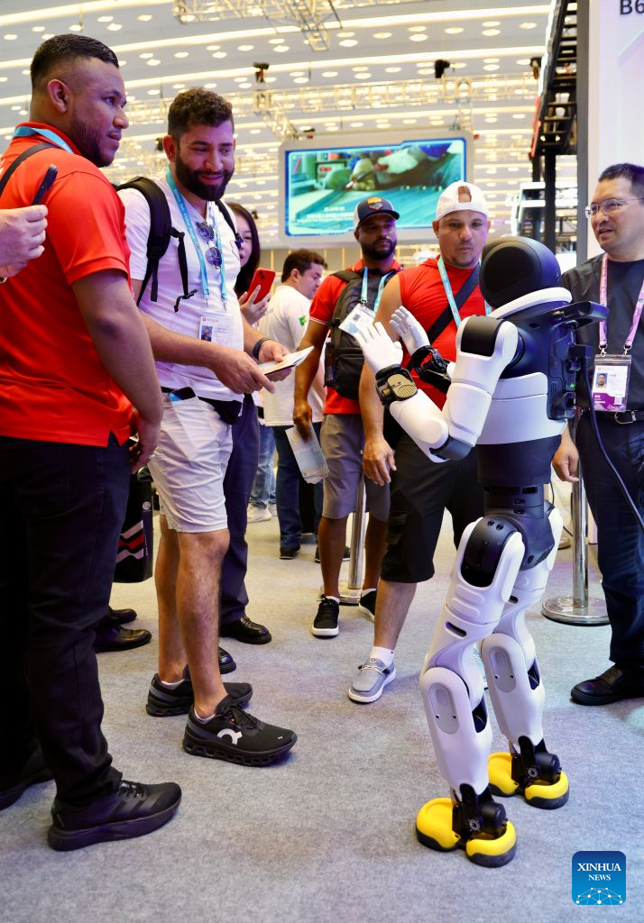 Overseas buyers interact with a robot during the Canton Fair in Guangzhou, south China's Guangdong Province, Oct. 15, 2026. The 140th edition of the China Import and Export Fair, also known as the Canton Fair, opened to visitors in Guangzhou, capital of south China's Guangdong Province on Thursday, with more than 30,000 exhibiting companies and about 340,000 overseas buyers expected to attend. Serving as a barometer and wind vane of China's foreign trade, this year's fair, marking its 70th anniversary, features innovation, intelligence, greater specialization and higher quality. The Canton Fair is one of the world's few one-stop trade platforms offering a complete range of products with convenience and efficiency, while bringing together the latest products and technologies. (Xinhua/Lu Hanxin)