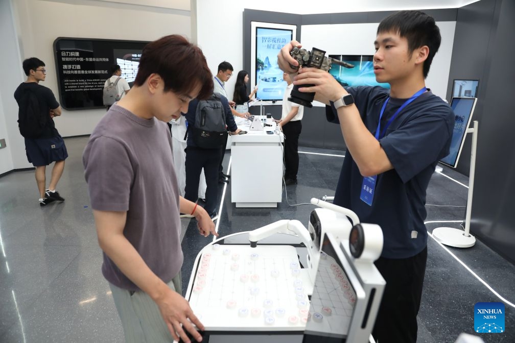 A visitor plays a board game with a robot at the China-ASEAN Countries Artificial Intelligence (AI) Application Cooperation Center in Nanning, south China's Guangxi Zhuang Autonomous Region, Oct. 12, 2026. Located in Nanning City, the China-ASEAN Countries Artificial Intelligence (AI) Application Cooperation Center serves as an important platform for south China's Guangxi Zhuang Autonomous Region to implement the national AI development strategy and deepen China-ASEAN cooperation in AI. (Photo: Xinhua)