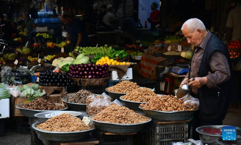 A vendor displays dried fruits at the central market in downtown Damascus, Syria, Oct. 13, 2026. (Photo: Xinhua)