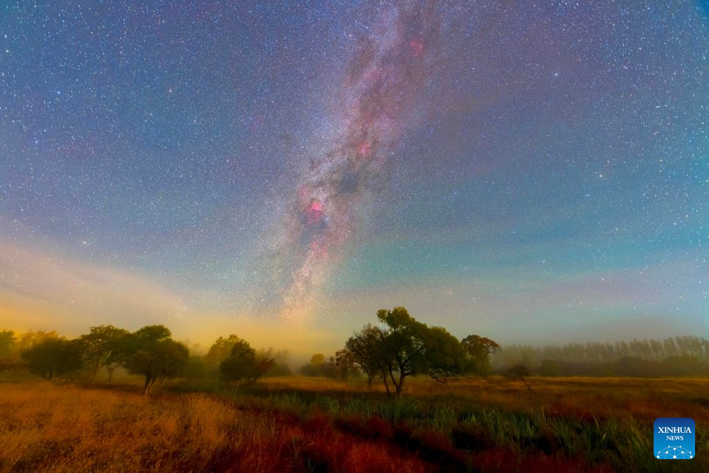 This stacked composite photo taken on Oct. 7, 2026 shows the autumn scenery under the Milky Way at the Jingpohu Global Geopark in Mudanjiang City, northeast China's Heilongjiang Province. (Photo by Wang Baoxun/Xinhua)
