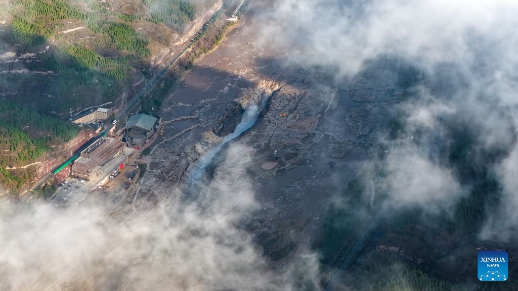 An aerial drone photo taken in Jixian County, north China's Shanxi Province on Oct. 13, 2026 shows the sea of clouds seen above the Yellow River's Hukou Waterfall. (Photo: Xinhua)
