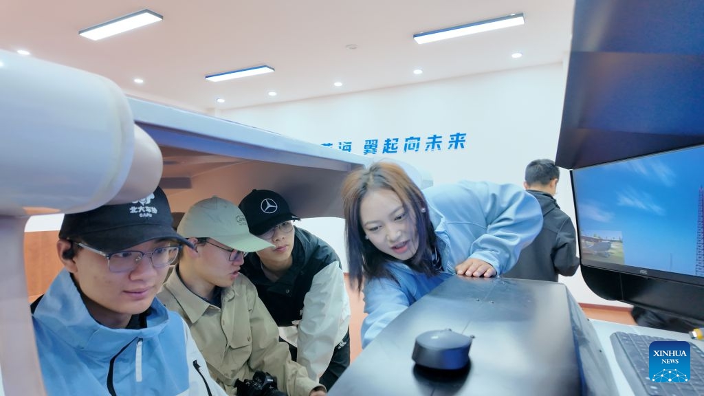 Ngorcog (1st R) instructs trainees during a flight simulator training session in Ruoergai County, southwest China's Sichuan Province, July 15, 2026. (Photo: Xinhua)
