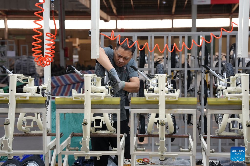 A worker is busy at the production base of Aima in Bac Ninh province, Vietnam, July 16, 2026. Chinese electric motorcycle brands are becoming an increasingly common sight on the streets of Vietnam's major cities, as the country accelerates its shift toward greener urban transport. More Vietnamese residents have turned to electric motorcycles, with Chinese brands emerging as popular choices thanks to their competitive prices, diverse models and growing presence in the Vietnamese market. (Photo: Xinhua)