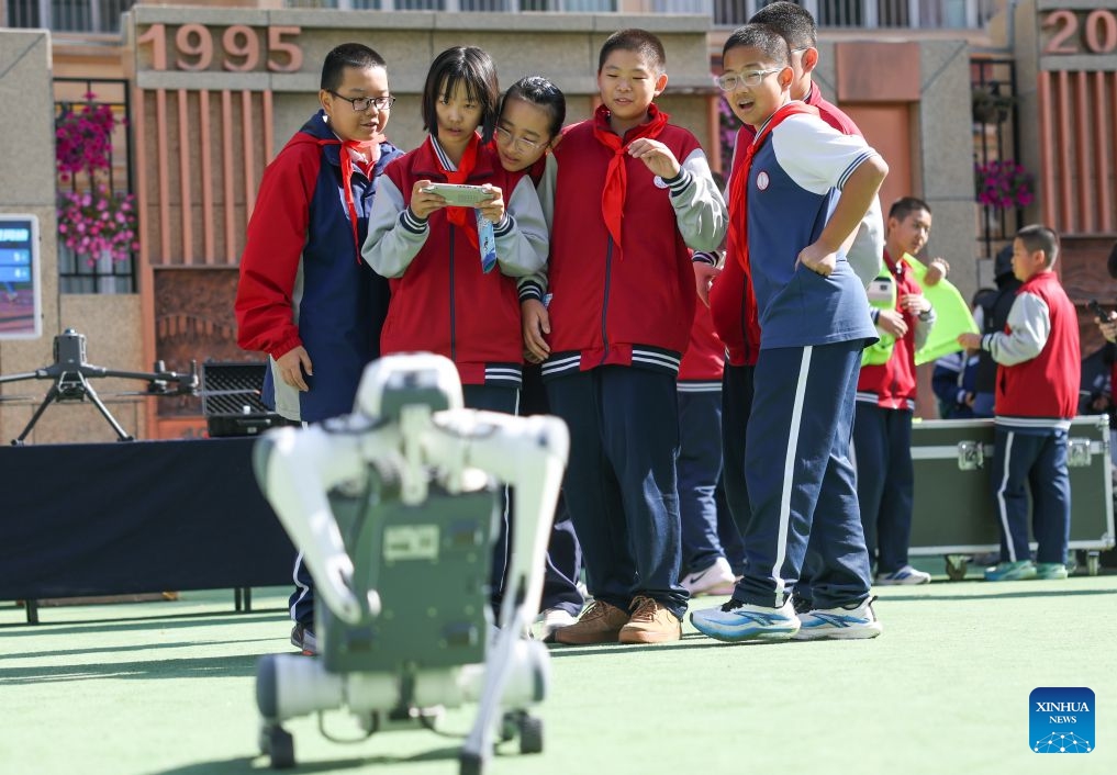 A student tries to remotely manipulate a robotic dog during a science and technology festival at a middle school in Urumqi, northwest China's Xinjiang Uygur Autonomous Region, Oct. 14, 2026. (Photo: Xinhua)