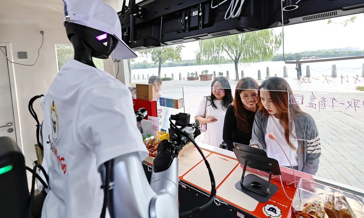 A humanoid robot named Xiaomai serves customers at a commercial complex in Jiaxing, East China's Zhejiang Province, on October 15, 2026. The city recently opened its first robot-operated convenience stores in the commercial complex. Besides selling products, the robot analyzes sales data to guide product selection, pricing and promotions. Photo: VCG