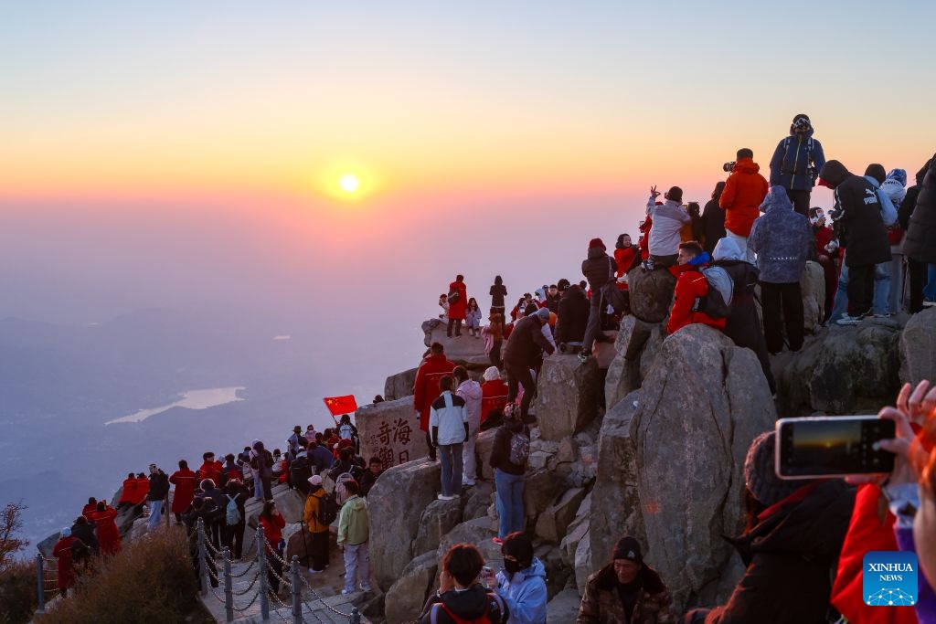 This photo taken on Oct. 8, 2026 shows tourists enjoying sunrise on Mount Tai in Tai'an City, east China's Shandong Province. Mount Tai, a UNESCO World Heritage Site, is one of China's most renowned mountains, known for its historical, cultural, aesthetic, and scientific significance. (Photo: Xinhua)