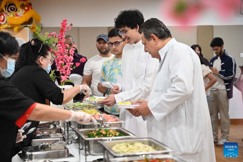 People taste dumplings during a Chinese culinary experience event in Hawalli Governorate, Kuwait, Oct. 13, 2026. Titled The Taste of China: Jiaozi (Dumpling) Experience, the event was organized by the China Cultural Center in Kuwait to introduce traditional Chinese food culture to local residents. More than 100 people participated in the event. (Photo: Xinhua)