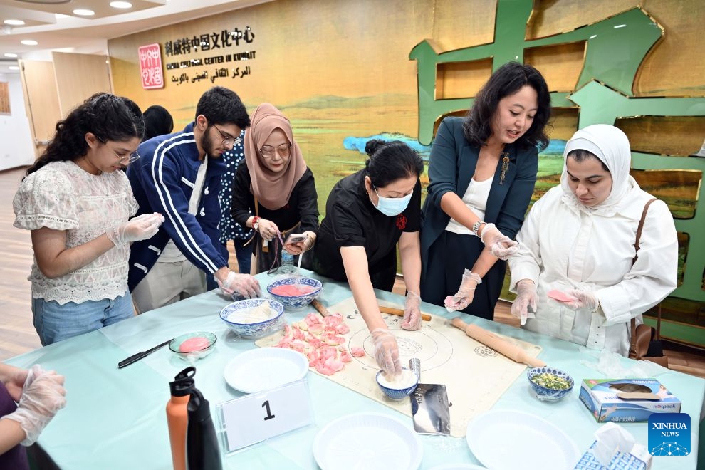 People participate in a Chinese culinary experience event in Hawalli Governorate, Kuwait, Oct. 13, 2026. Titled The Taste of China: Jiaozi (Dumpling) Experience, the event was organized by the China Cultural Center in Kuwait to introduce traditional Chinese food culture to local residents. More than 100 people participated in the event. (Photo: Xinhua)