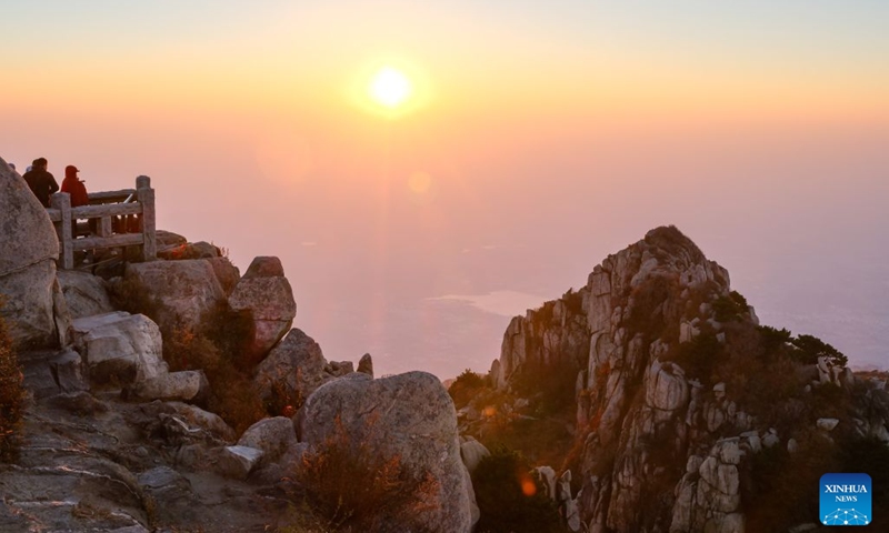 This photo taken on Oct. 8, 2026 shows tourists enjoying sunrise on Mount Tai in Tai'an City, east China's Shandong Province. Mount Tai, a UNESCO World Heritage Site, is one of China's most renowned mountains, known for its historical, cultural, aesthetic, and scientific significance. (Photo: Xinhua)