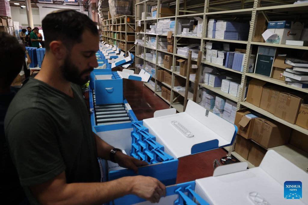 A worker prepares ballot boxes at a logistics center near the central Israeli city of Modiin, Oct. 14, 2026. The general elections for Israel's Knesset, the country's parliament, will be held on Oct. 27. All the preparations for the election are underway. (Photo: Xinhua)
