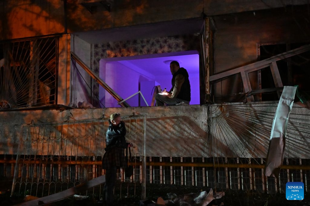 People check a residential building after a strike in Kiev, Ukraine, Oct. 14, 2026. (Photo: Xinhua)