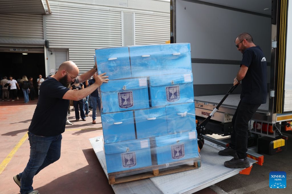 Workers transfer ballot boxes at a logistics center near the central Israeli city of Modiin, Oct. 14, 2026. The general elections for Israel's Knesset, the country's parliament, will be held on Oct. 27. All the preparations for the election are underway. (Photo: Xinhua)