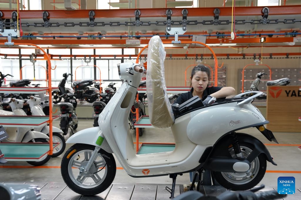 A worker is busy at the manufacturing plant of Yadea in Bac Ninh province, Vietnam, July 7, 2026. Chinese electric motorcycle brands are becoming an increasingly common sight on the streets of Vietnam's major cities, as the country accelerates its shift toward greener urban transport. More Vietnamese residents have turned to electric motorcycles, with Chinese brands emerging as popular choices thanks to their competitive prices, diverse models and growing presence in the Vietnamese market. (Photo: Xinhua)