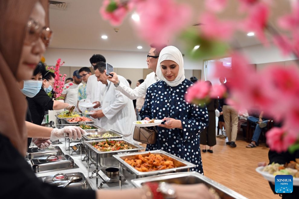 People participate in a Chinese culinary experience event in Hawalli Governorate, Kuwait, Oct. 13, 2026. Titled The Taste of China: Jiaozi (Dumpling) Experience, the event was organized by the China Cultural Center in Kuwait to introduce traditional Chinese food culture to local residents. More than 100 people participated in the event. (Photo: Xinhua)