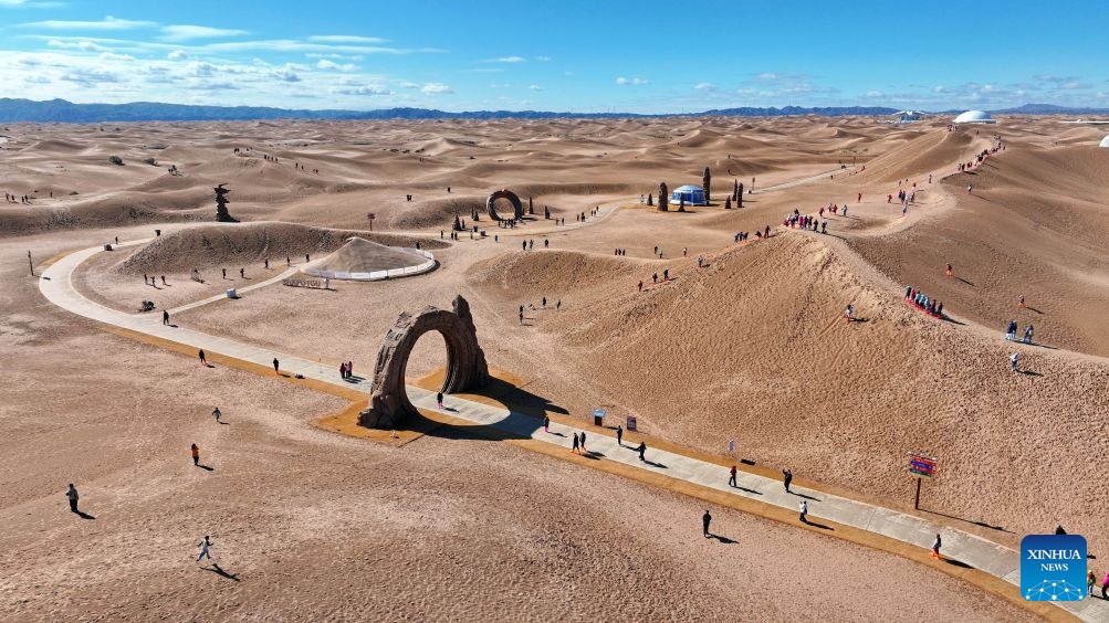 An aerial drone photo taken on Oct. 17, 2026 shows tourists visiting the Tengger Desert in Zhongwei, northwest China's Ningxia Hui Autonomous Region. Marking the beginning of a desert self-driving event, a ceremony was held here on Saturday, gathering more than 500 vehicles for self-driving tours and over 1,000 tourists. (Xinhua/Wang Peng)