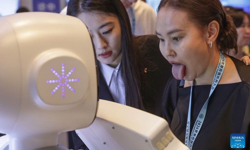 Guests interact with an embodied robot providing Traditional Chinese Medicine (TCM) services during World Conference on Traditional Medicine 2026 in Beijing, capital of China, Oct. 17, 2026. Guests from home and abroad have gathered together to experience and feel the charm of Traditional Chinese Medicine (TCM) during World Conference on Traditional Medicine 2026 and the Beijing International Traditional Healthcare Exhibition, which kicked off here on Saturday and Friday respectively. (Xinhua/Zhang Yuwei)

