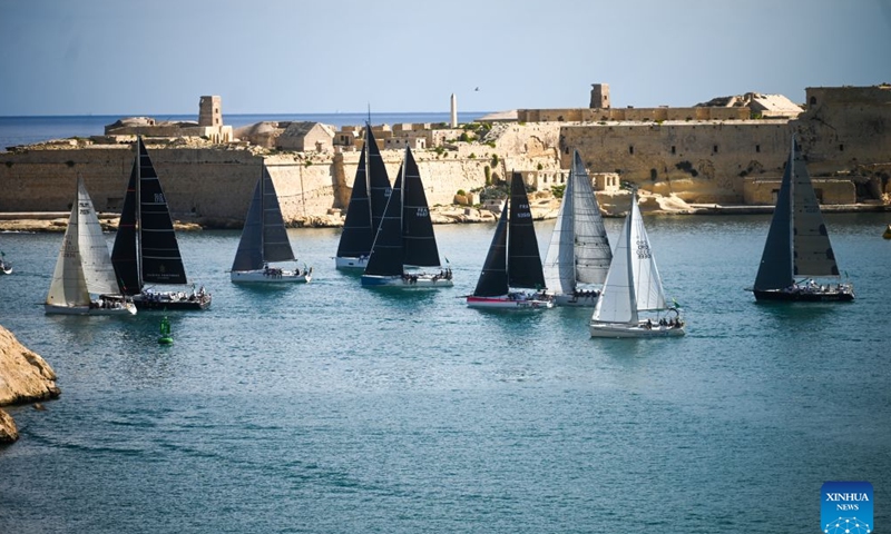Yachts are seen sailing from the Grand Harbour of Malta, port of Valletta, during the 47th Rolex Middle Sea Race in Valletta, Malta, on Oct. 17, 2026. (Photo by Jonathan Borg/Xinhua)